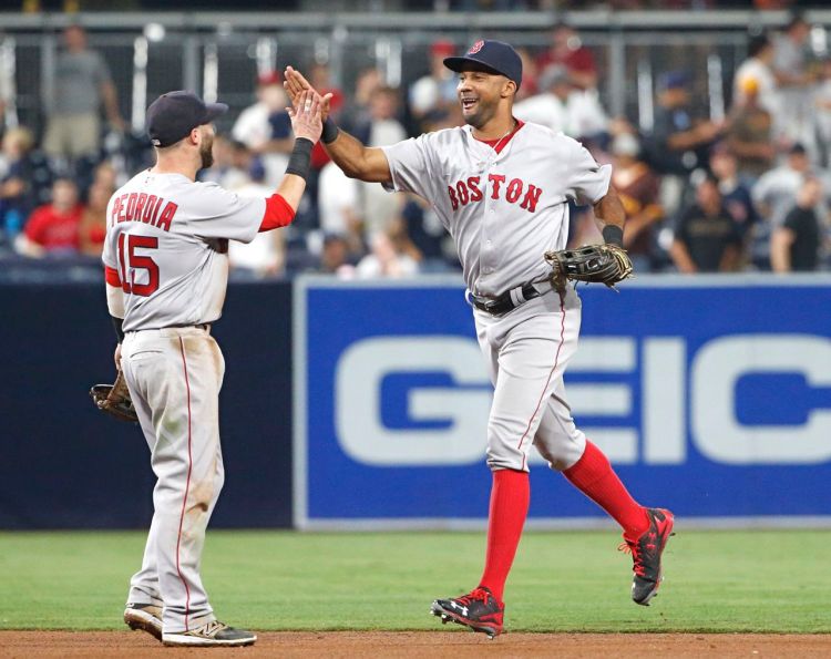 Chris Young, right, high-fives Dustin Pedroia after the Red Sox defeated the San Diego Padres 5-1 Tuesday night in San Diego. Young homered in the game. <em>Lenny Ignelzi/Associated Press</em>