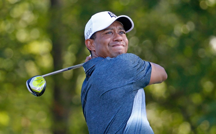 Tiger Woods watches his tee shot on the 13th hole during the Quicken Loans National golf tournament, in Gainesville, Va. , on July 31, 2015. <em>Steve Helber</em>