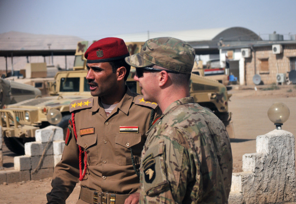 U.S. Army Capt. Gerrard Spinney, right, speaks to his counterpart in the Iraqi army before a Sept. 6 security meeting at Camp Swift, Iraq. Speeding up the Mosul offensive could set the stage for catastrophe.