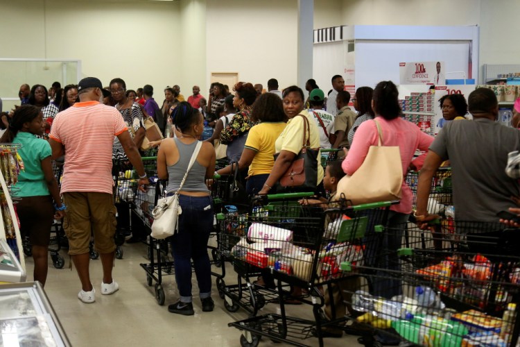 Jamaicans flock to the supermarkets to take care of last-minute shopping pending the arrival of Hurricane Matthew in Kingston, Jamaica, on Friday.