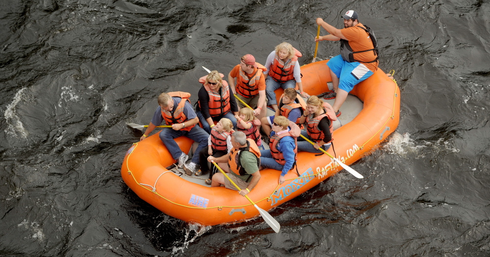 A raft carries whitewater enthusiasts on a free float trip down the Kennebec River during the annual River Festival in Skowhegan in 2014. A proposal for a whitewater park in Skowhegan could bring many more rafts and kayaks down the river and generate about $6 million in revenue and 43 new jobs in its first year of operation, an economic impact study says.