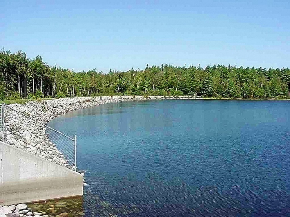 This September 1999 handout photo shows the south shore and spillway at Carleton Pond. Officials are considering the formation of a new group that would write regulations to allow some access to the pond.