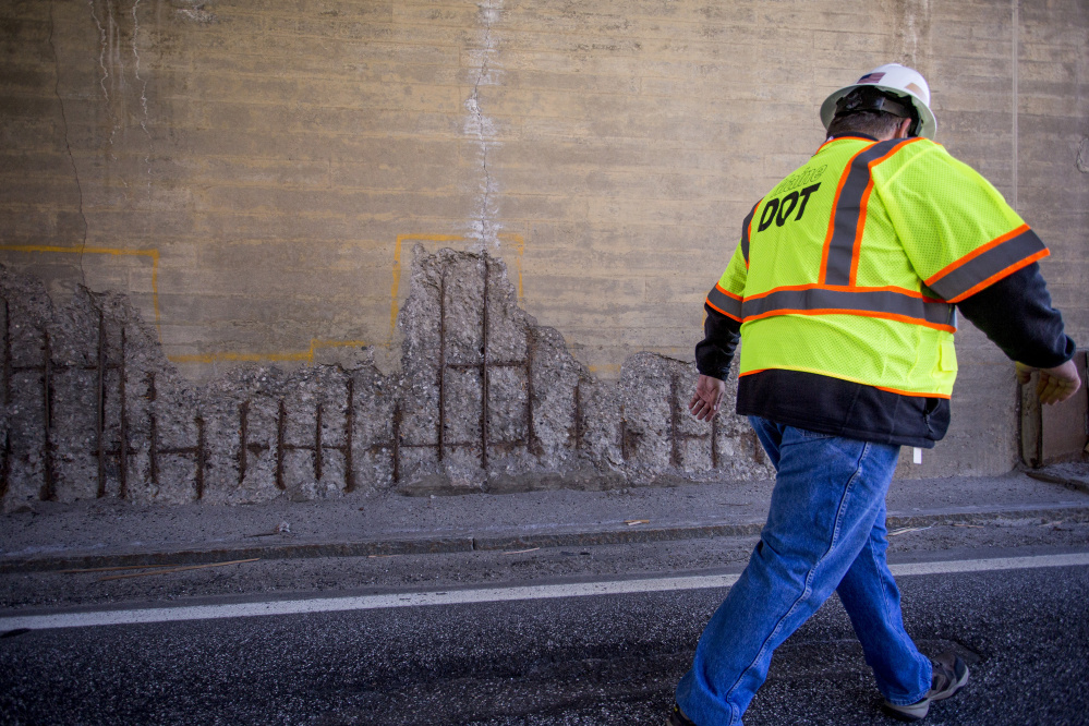 Maine DOT press secretary Ted Talbot walks off the Route 1 Viaduct in Bath past some corrosion on the bridge supporting High Street last April. 
Gabe Souza/Staff Photographer