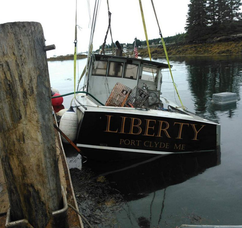 Anthony Hooper's lobster boat is hauled out of the water after it was intentionally sunk on Aug. 17.