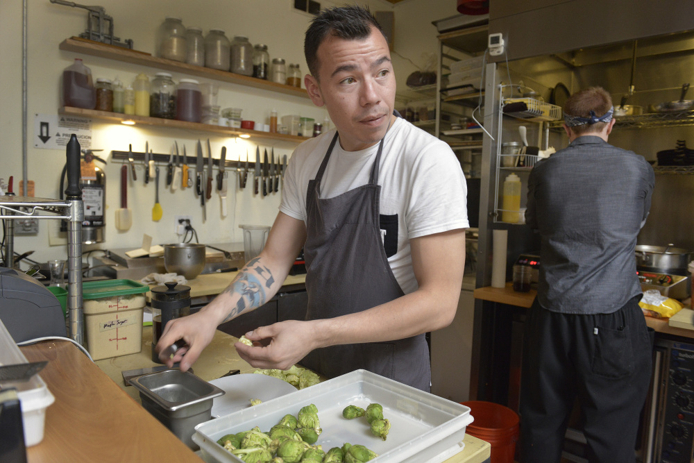 Greenland chef Inunnguaq Hegelund prepares brussels sprouts Monday on the line at Vinland restaurant in Portland. Photos by John Ewing/Staff Photographer