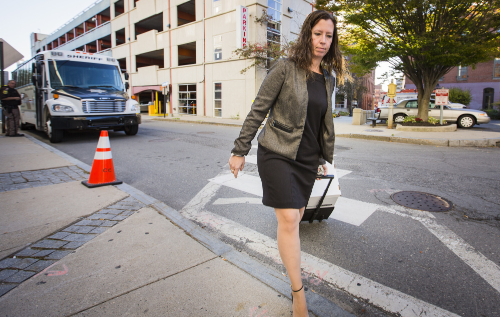 Sarah Churchill, a member of the defense team for landlord Gregory Nisbet, arrives at the Cumberland County courthouse Wednesday. The defense is arguing that Nisbet rented out the Noyes Street house as a duplex, so it didn't have to meet stricter fire safety codes that apply to rooming houses.