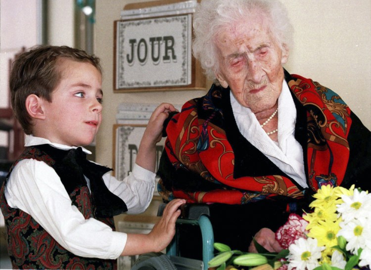 Jeanne Calment receives flowers from a boy in 1997. She attributed her longevity to a diet rich in olive oil, wine and chocolate.