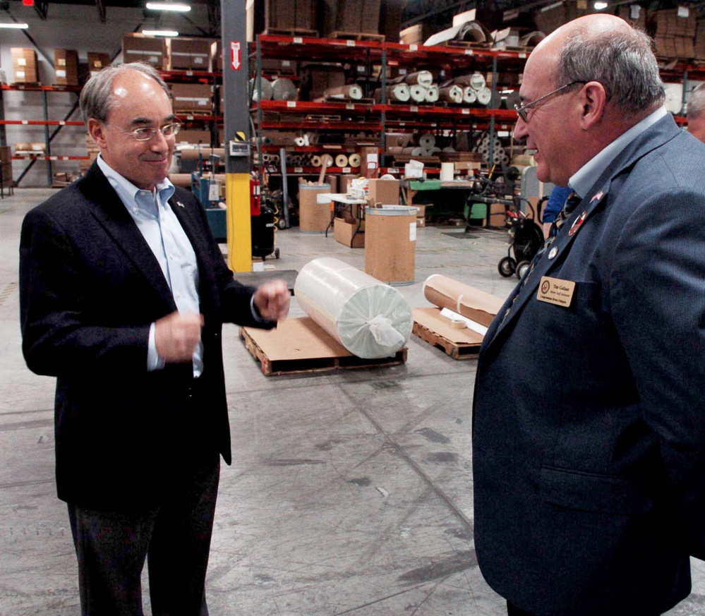 U.S. Rep. Bruce Poliquin, left, shown speaking with Auburn Manufacturing's Tim Gallant, has supported the company's pursuit of relief from lower-priced imports.