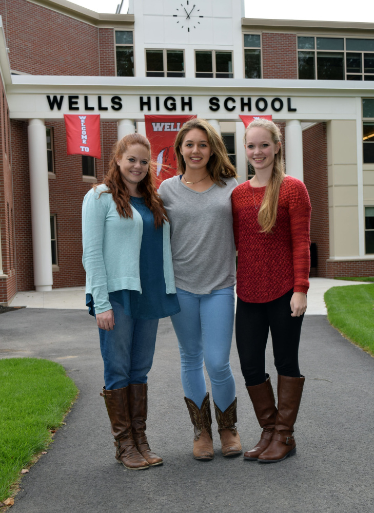 Wells High School Color Guard coach Bailey Smith, left,  with squad members Bella White and Jessica Bacon, along with Mallory Cashman, will travel to New York Thanksgiving week to practice drills for their appearance in the Macy's Thanksgiving Day Parade.
