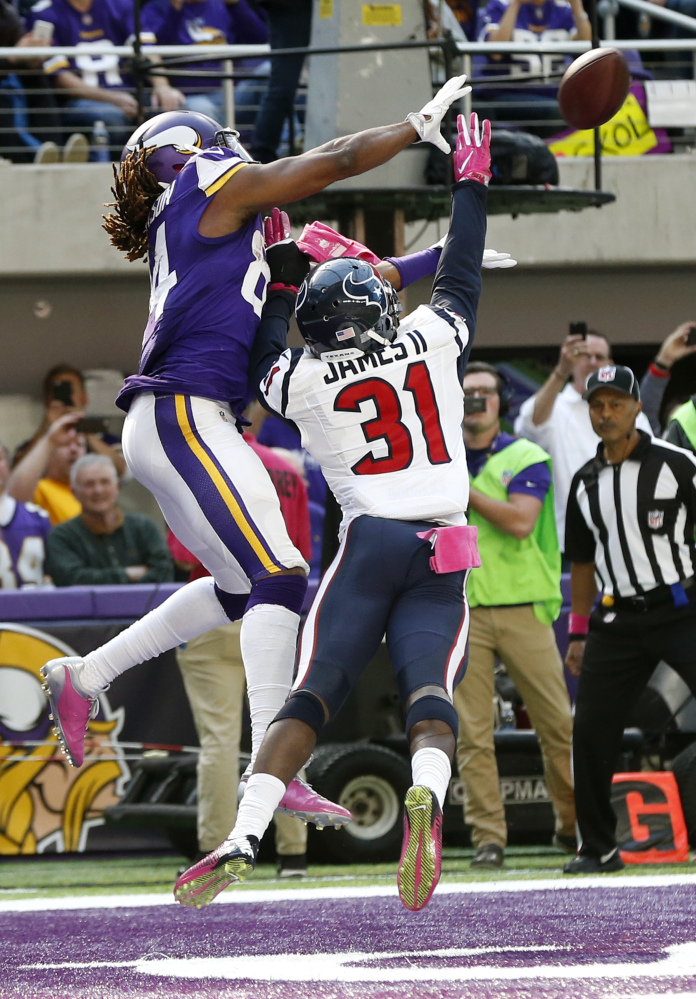 Minnesota Vikings wide receiver Cordarrelle Patterson, left, catches a 9-yard touchdown pass over Houston Texans defensive back Charles James (31) during the second half of an NFL football game Sunday, Oct. 9, 2016, in Minneapolis. (AP Photo/Jim Mone)