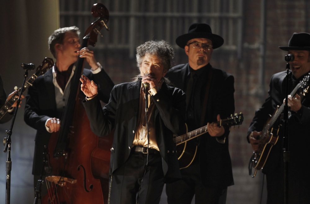 Bob Dylan, center, performs Feb. 13, 1981 at the 53rd annual Grammy Awards in Los Angeles. Dylan won the 2016 Nobel Prize in literature on Thursday, a stunning announcement that for the first time bestowed the prestigious award on a musician for "having created new poetic expressions within the great American song tradition."