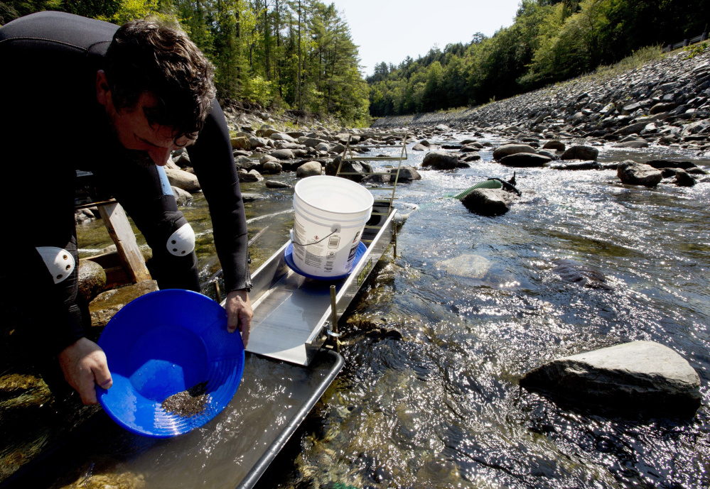 Chris Hall uses a sluice box to pan for gold Sept. 4 in the Wild Ammonoosuc River in Bath, N.H. A new generation of gold miners is giving prospecting a try, especially in New England and the Pacific Northwest.