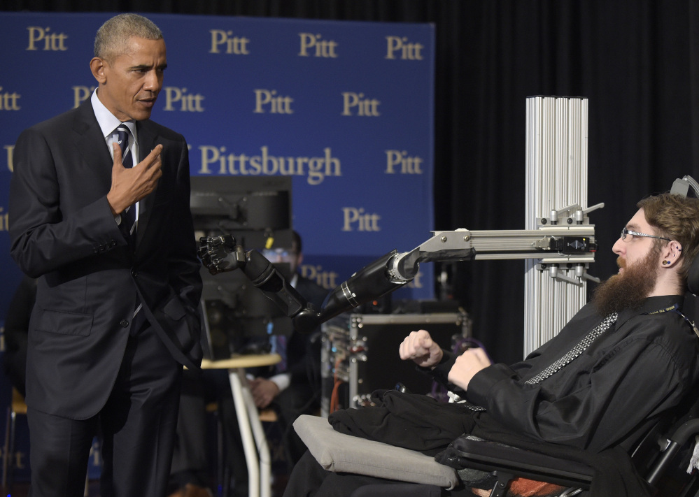 President Obama talks with Nathan Copeland, right, in Pittsburgh on Thursday. "What a story," Obama said after shaking and fist-bumping Copeland's prosthetic hand.