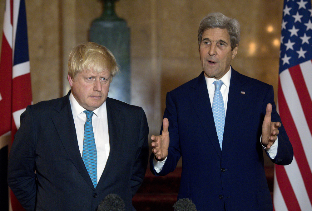 U.S. Secretary of State John Kerry, right, and British Foreign Secretary Boris Johnson discuss Syria at a news conference. in London.