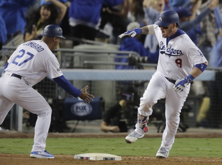 The Dodgers' Yasmani Grandal celebrates after hitting a two-run home run in the fourth inning of Game 3 of the National League Championship Series on Tuesday night in Los Angeles.
