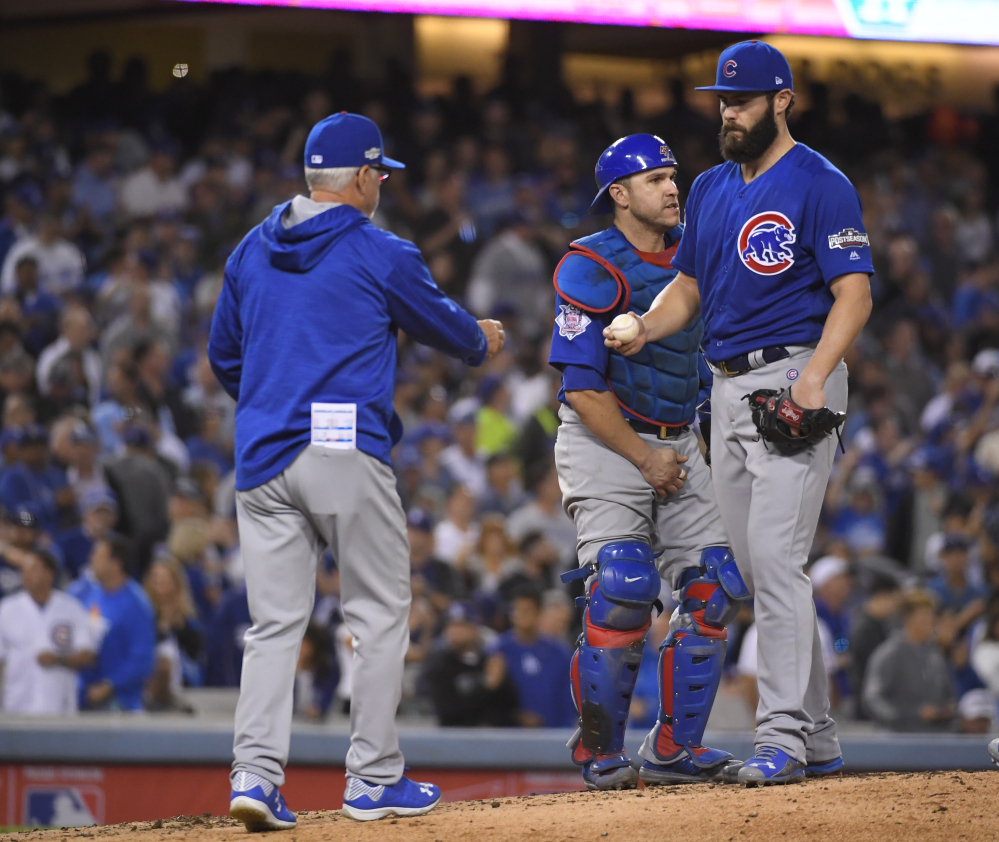 Cubs manager Joe Maddon takes starter Jake Arrieta out of the game in the sixth inning, trailing 4-0. Arrieta gave up four runs on six hits in a disappointing outing.
