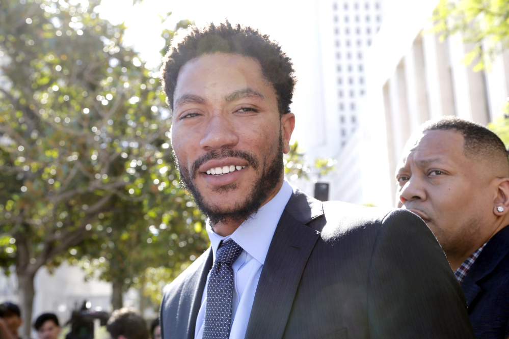 NBA star Derrick Rose leaves federal court in Los Angeles on Wednesday after jurors cleared him and two friends in a lawsuit that accused them of gang raping his ex-girlfriend when she was incapacitated from drugs or alcohol.