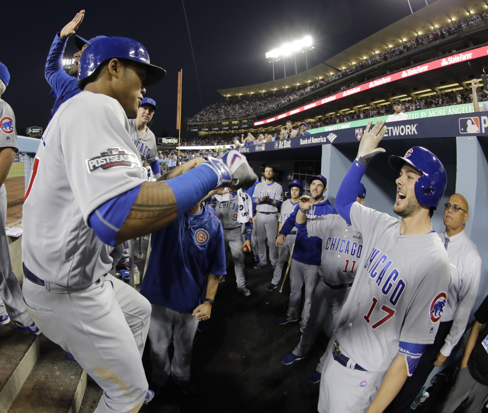 Addison Russell of the Cubs is congratulated after hitting a two-run home run in the fourth inning of Game 4 of the NLCS Wednesday night in Los Angeles.