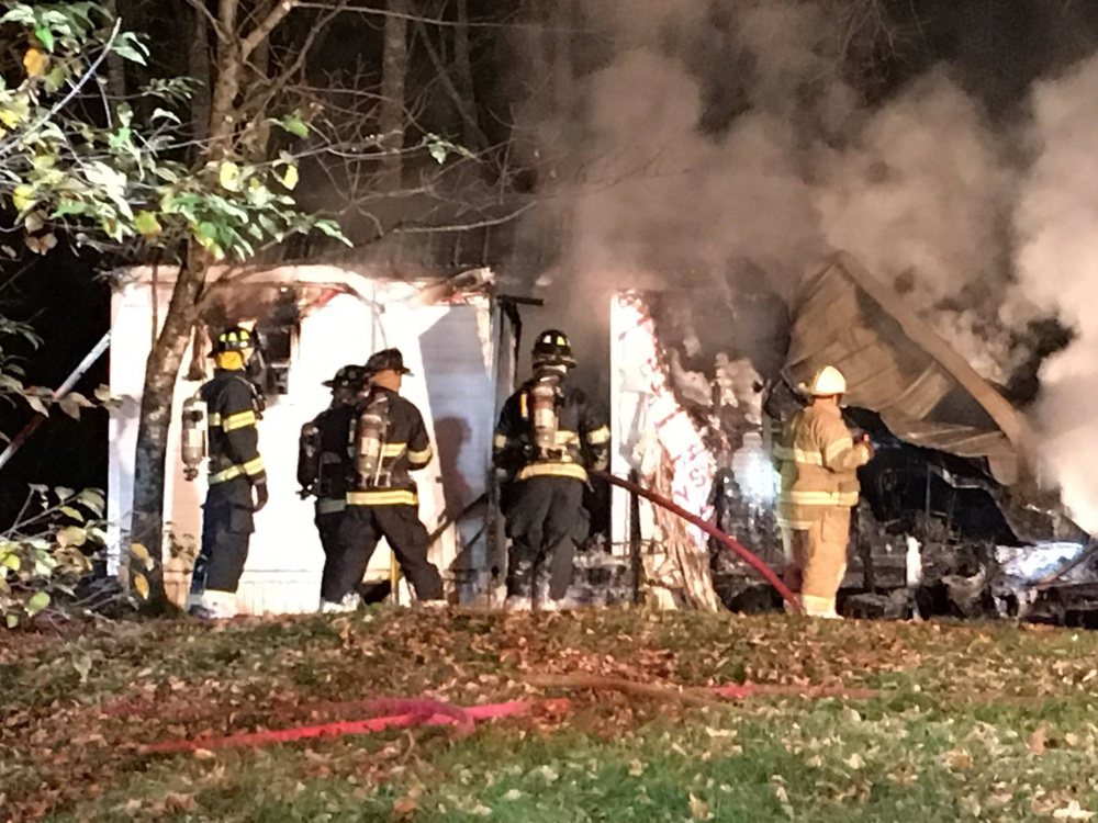 A mobile home was destroyed by fire on Route 133 in Winthrop early Thursday, and police later charged the homeowner with arson.