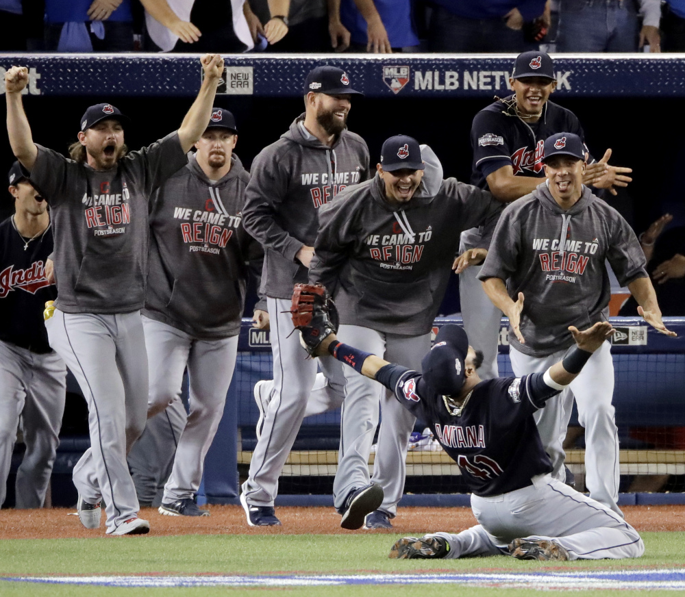 Indians first baseman Carlos Santana celebrates after making the final out in Cleveland's series-clinching 3-0 win over Toronto in the American League Championship Series. Four months after the NBA's Cavaliers won a title, the Indians are poised to give the city another.