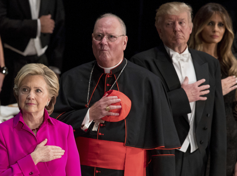 From left, Hillary Clinton, Cardinal Timothy Dolan, Donald Trump and his wife, Melania Trump, stand for the national anthem at a charity gala Thursday.