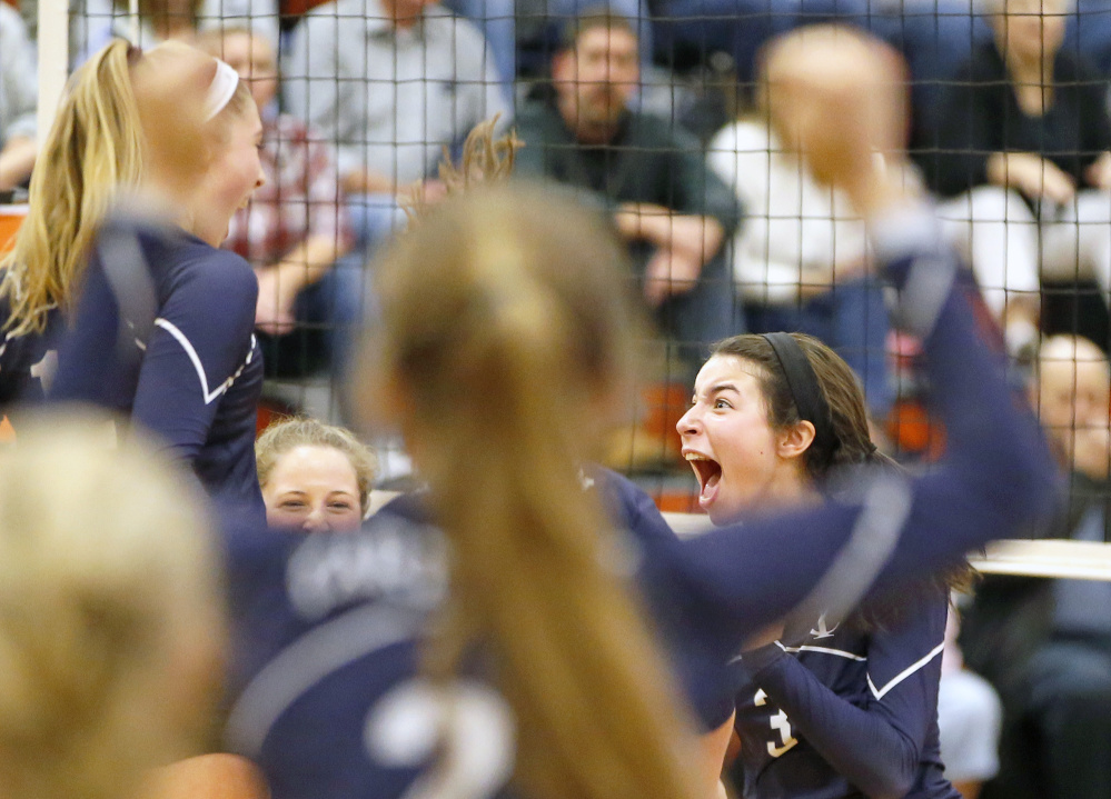 Yarmouth's Marie LeBlanc celebrates with teammates Saturday after the winning point against Biddeford in a Class A volleyball quarterfinal.