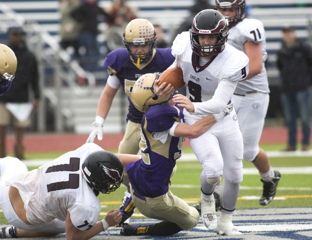 Windham running back Kyle Houser powers through the Cheverus defense in the second half Saturday at Fitzpatrick Stadium in Portland. Windham rallied in the second half for a 13-12 win.
