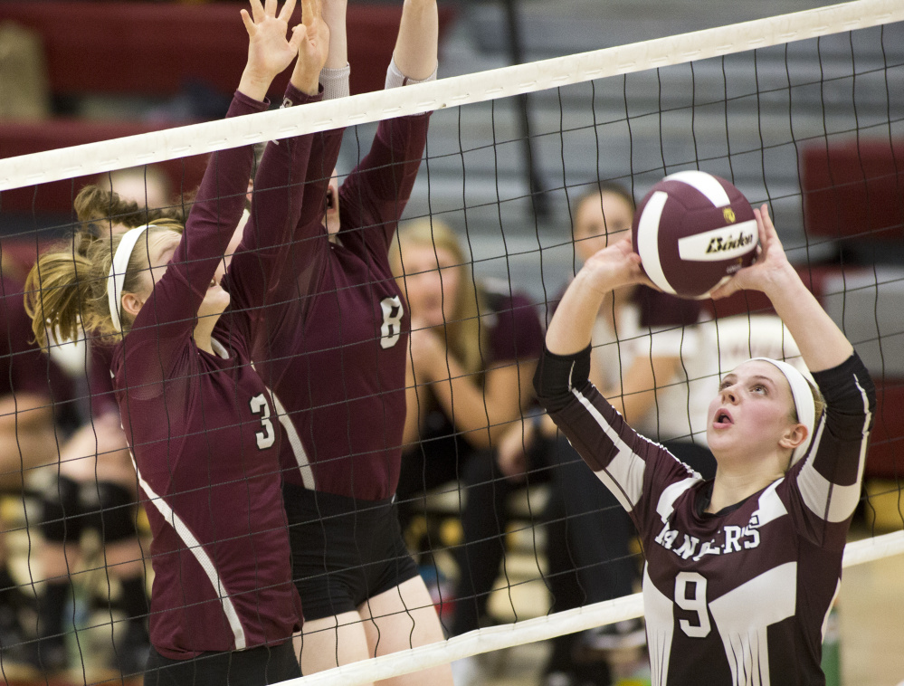 Kayley Cimino of Greely, right, sets the ball as Caralin Mills, left, and Kristen Curley of Gorham jump up to the net to block during Greely's 3-1 victory Saturday in a Class A volleyball quarterfinal. The undefeated Rangers will be home against Falmouth in the semifinals Wednesday.