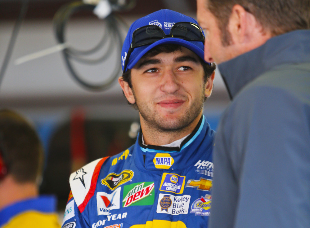 Sprint Cup Series driver Chase Elliott, center, hangs out in the garage area before practice for Sunday's NASCAR Sprint Cup auto race at Talladega Superspeedway, Friday, Oct. 21, 2016, in Talladega, Ala. (AP Photo/Butch Dill)