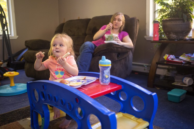 Samantha Watson and her 2-year-old daughter, Audree, eat lunch at home in Parsonsfield. Watson, a 25-year-old single mother, bristles at the idea that recipients of Temporary Assistance for Needy Families are squandering their benefit or that they can't be trusted to spend the money responsibly.