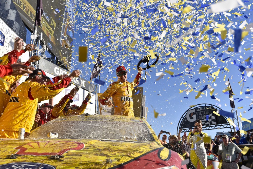 Joey Logano celebrates after his Sprint Cup victory Sunday at Talladega Superspeedway. Logano clinched a spot in the next-to-last round of the playoffs and is one of eight drivers still in contention for the championship.