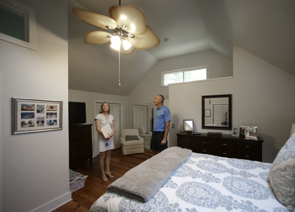 Real estate agent Lauren Newman, left, shows client Steve Martin a home for sale in Mount Pleasant, S.C. Home sales in the U.S. climbed at a solid pace in August, according to a 20-city home price index.
