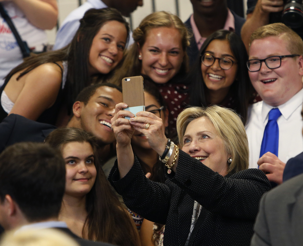 Democratic presidential candidate Hillary Clinton takes a photo with supporters after speaking at Fort Hayes Vocational School in Columbus, Ohio. A new poll finds that young voters are starting to come through for Clinton, particularly among whites ages 18 to 30.