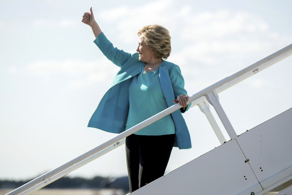 Democratic presidential candidate Hillary Clinton gives a thumbs people who cheer for her as she boards her campaign plane at Tampa International Airport in Tampa, Wednesday, Oct. 26, 2016. (AP Photo/Andrew Harnik)