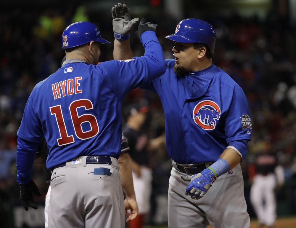Kyle Schwarber of the Cubs is congratulated by first-base coach Brandon Hyde after hitting an RBI single in the fifth inning of Game 2 of the World Series Wednesday night against the Cleveland Indians.