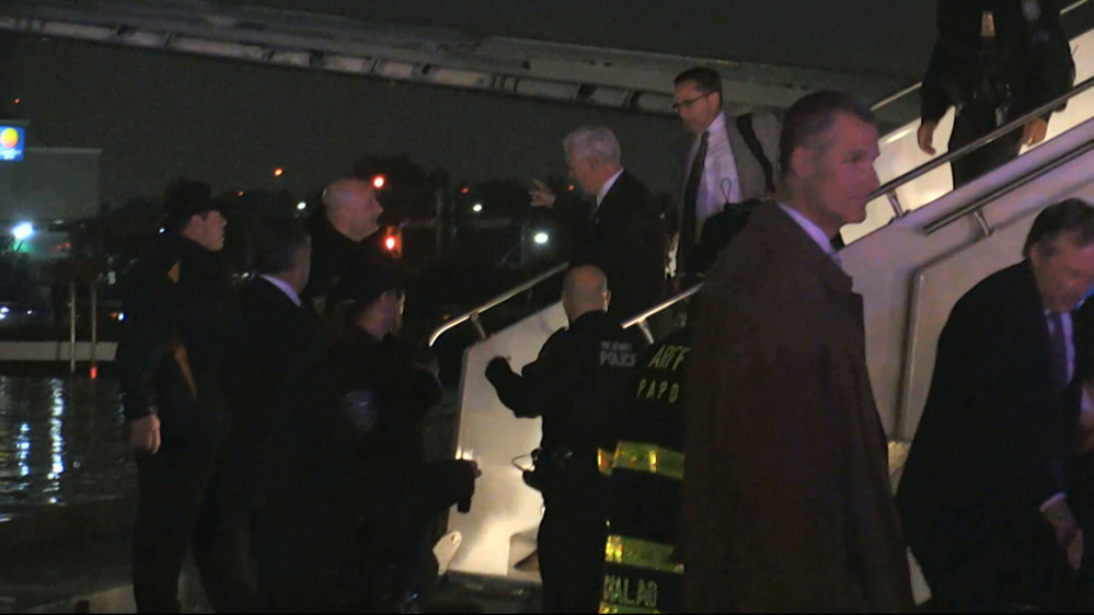 Republican vice presidential candidate Mike Pence walks down the steps of his campaign plane at New York's LaGuardia Airport on Thursday after it slid off the runway while landing.