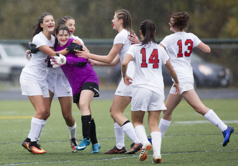 The Scarborough High girls' soccer team celebrates after winning its Class A South semifinal against Windham, 2-0, on Saturday afternoon in Scarborough. (Photo by Brianna Soukup/Staff Photographer)