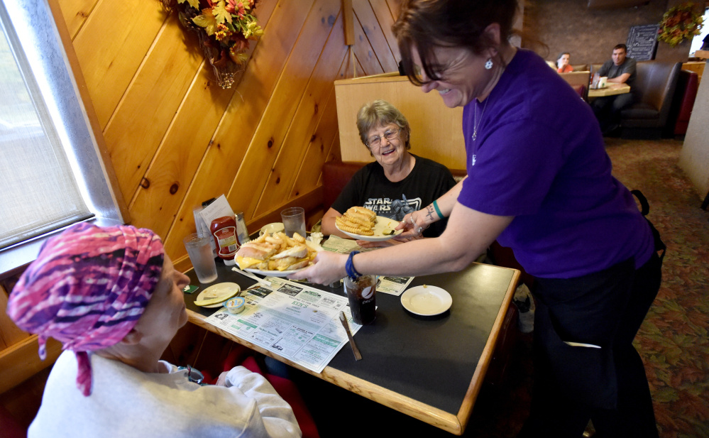 Tammie Webber delivers hot food to Janice Beane, left, and her mother, Orlene Beane, both of Bingham, at Ken's Family Diner in Skowhegan. 