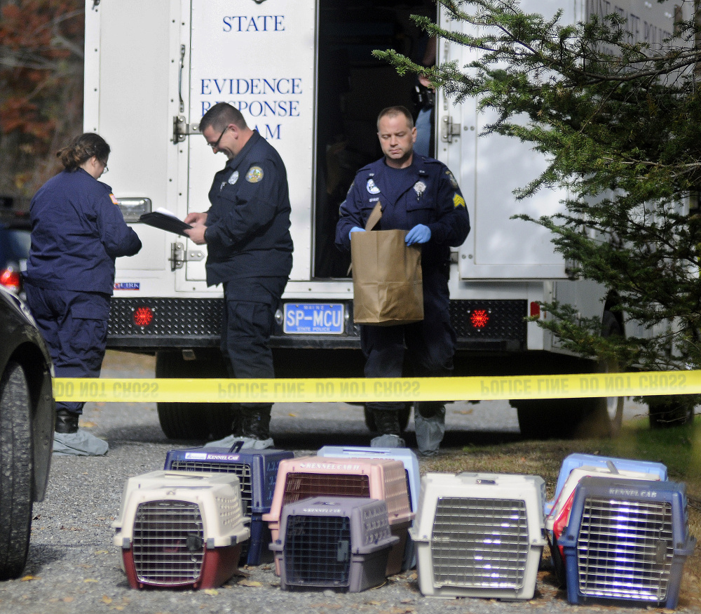Maine State Police collect evidence from the home in Winthrop where two bodies were discovered early Monday morning. Several pets were removed from the home.
