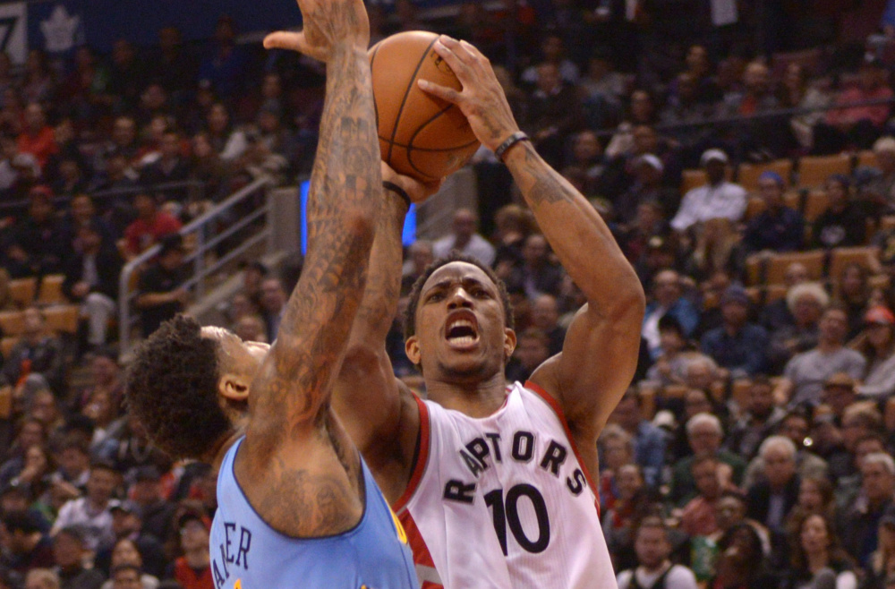Toronto's DeMar DeRozan shoots over Denver's Wilson Chandler during the first half of the Raptors' 105-102 win Monday night at Toronto. DeRozan finished with 33 points, his third straight game scoring over 30.