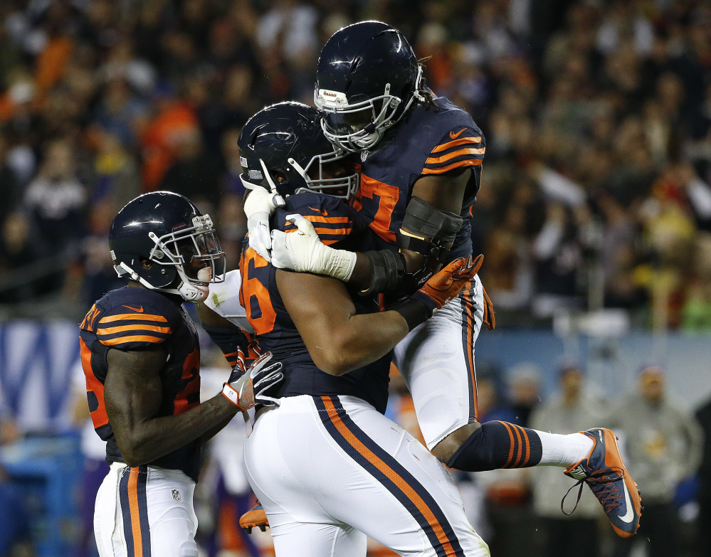 Chicago defensive end Akiem Hicks, center, celebrates a sack with Sherrick McManis, right, during the Bears' 20-10 win Monday night over the Vikings.