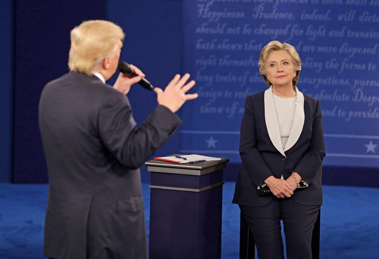 Hillary Clinton listens to  Donald Trump during the second presidential debate on Oct. 9, 2016,  in St. Louis. National polls have moved in Clinton's direction since the exchanges began in late September. <em>Associated Press/John Locher</em>