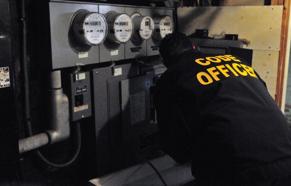 City of Augusta Code Enforcement Officer Robert Overton checks out an electrical system during an Oct. 2 inspection of an apartment building.