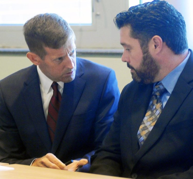 Bryan Carrier, right, and his attorney, Walt McKee, confer during a hearing Sept. 26 in Augusta at the Bureau of Motor Vehicles, where Carrier asked to have his drivers license restored. Andy Molloy/Kennebec Journal
