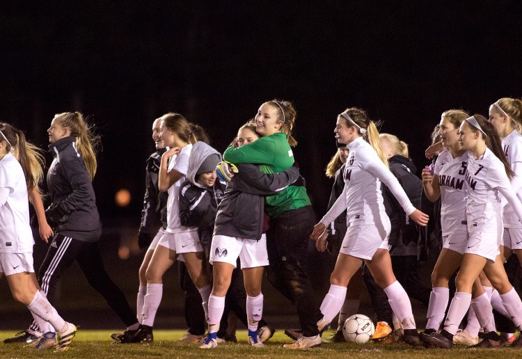 Gorham players celebrate after winning a berth in the Class A South final with a 2-0 win over Falmouth on Monday.