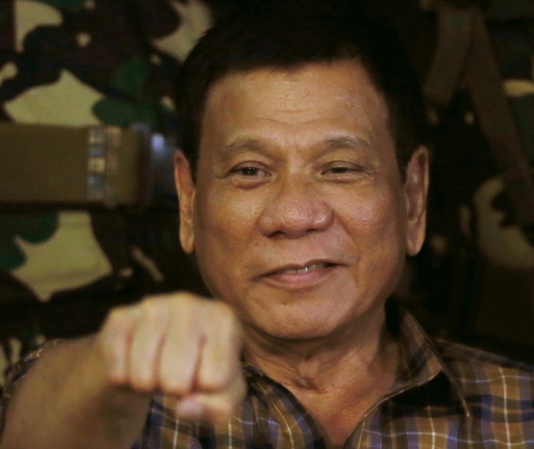 Philippine President Rodrigo Duterte gestures with a fist bump during a visit to an army camp on Aug. 25.
Associated Press/Bullit Marquez