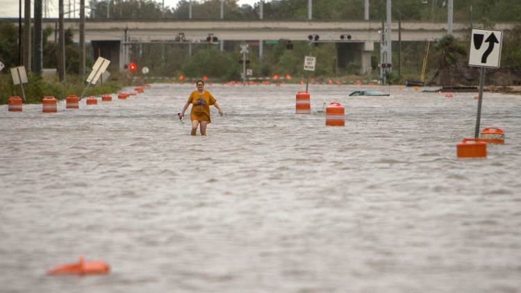 A woman walks along flooded President Street in Savannah, Ga., after leaving her homeless camp during Hurricane Matthew on Saturday.
Associated Press/Stephen B. Morton