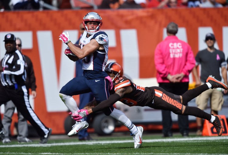 Patriots wide receiver Chris Hogan is tackled by Cleveland Browns cornerback Joe Haden after a long pass in the first half.