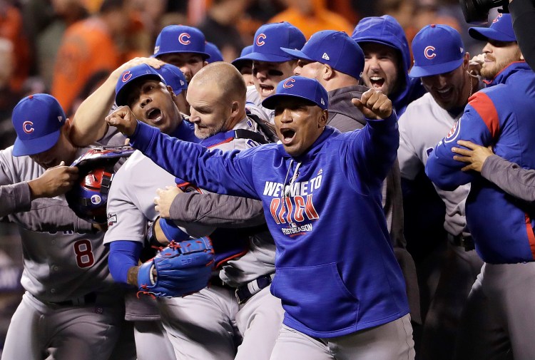 Chicago Cubs pitcher Aroldis Chapman, second from left, catcher David Ross, third from left, and teammates celebrate after Game 4 on Tuesday.    Associated Press/Marcio Jose Sanchez