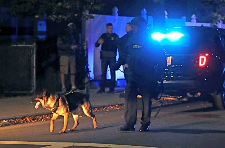 Police patrol an East Boston neighborhood after a shooting late Wednesday. <em>Charles Krupa/Associated Press</em>